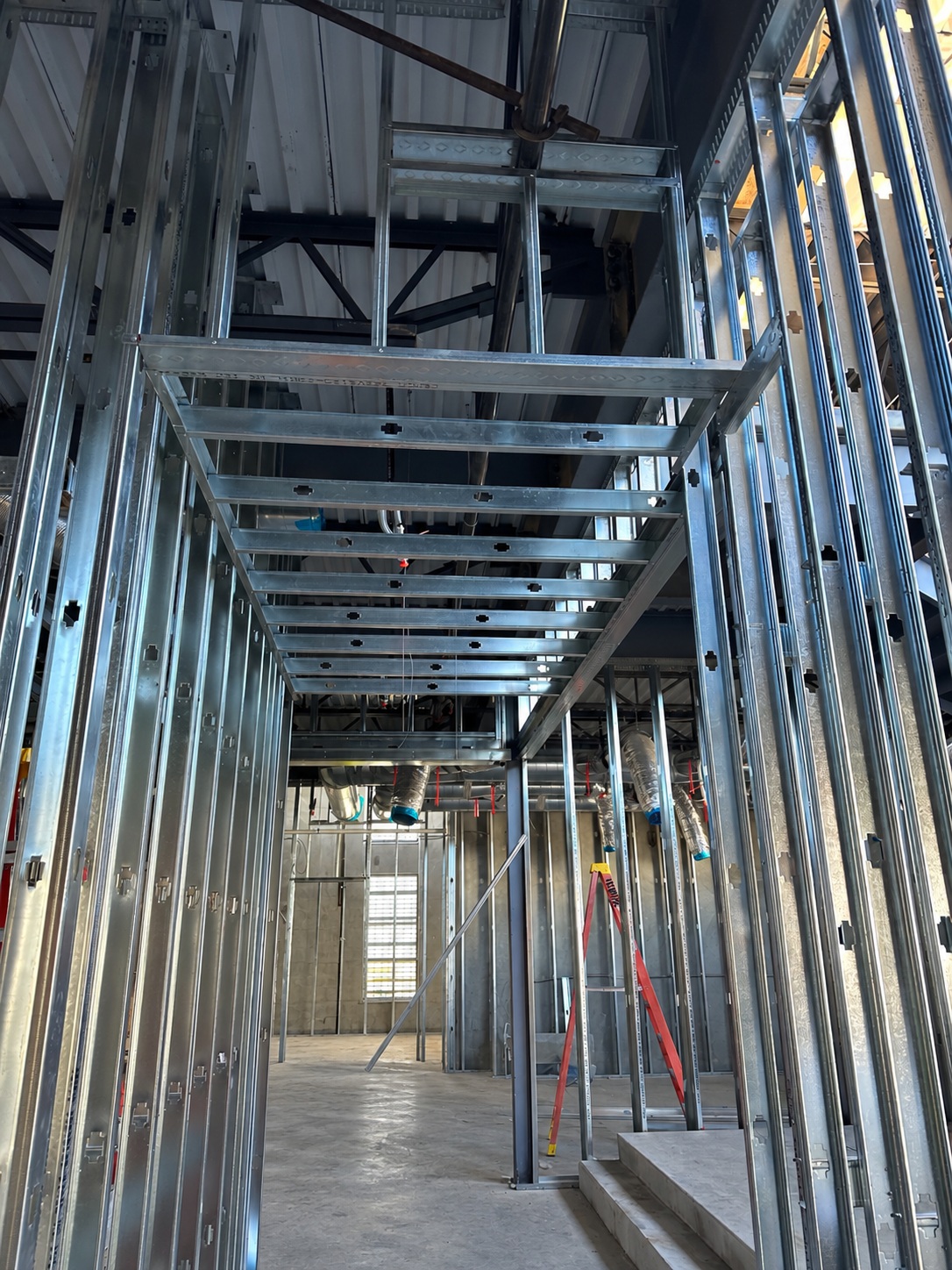Metal framing for hard lids and soffits beneath an exposed commercial ceiling